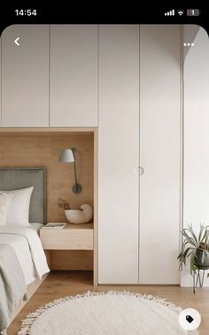 a bedroom with white walls and wooden flooring