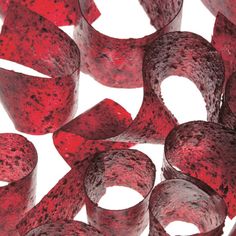 red rubber banding on white background with clippings for use in jewelry making