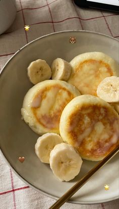 some bananas and pancakes on a plate with chopsticks