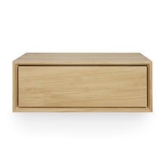 a wooden box sitting on top of a white wall