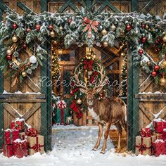 a deer standing in front of a wooden gate with christmas decorations and presents on it