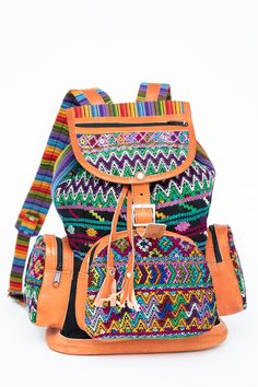 One of a Kind - ﻿﻿Guatemalan Huipil Bag The ultimate back-to-school backpack, each of these Guatemalan leather backpacks is as colorful as it is cultural. Each colorful backpack is handmade from sueded leather and huipil fabric used for traje tipico or traditional dress in different regions of Guatemala. Coupled with padded backs made of multicolored traditional jaspe textiles, each one of these colorful leather backpacks is as unique as you are. The red huipil fabrics are from the town of Nebaj Handmade Leather Backpack, Mayan Culture, Backpack Free, Back To School Backpacks, Colorful Backpacks, Leather Backpacks, School Backpack, Colored Leather, Traditional Dress