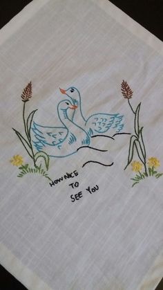 a white towel with two ducks on it