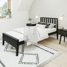 a white and black bedroom with a bed, night stand, nightstands and window