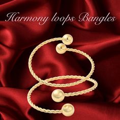 Harmony Loops Twisted Ball Bangles is a stunning fusion of tradition and elegance. Crafted with meticulous care, these bangles are designed to celebrate cultural richness. The Harmony Loops Bangles come in a set of two, meticulously crafted to adorn your wrists with grace and style. Intricately twisted and adorned with ball accents, these bangles exude a timeless charm that captures the essence of fine craftsmanship. We take pride in offering you not just beauty, but also peace of mind. Our bangles are Cadmium-Free and Lead-Free, ensuring they are safe to wear for extended periods. Moreover, they are expertly plated with real 18K gold, providing a luxurious finish that gleams with sophistication. With a size of approximately 2-1/2 inches (6.2 cm) in inner diameter and ranging from 3 to 26 Elegant Gold-plated Bracelet For Festivals, Elegant Gold Plated Bangle For Festivals, Adjustable Elegant Gold Bracelet For Festive Occasions, Elegant Bangle Bracelets For Festivals, Elegant Adjustable Gold Bracelet For Festive Occasions, Elegant Gold Bangle For Celebration, Elegant Round Bangle For Celebration, Elegant Bracelets For Festivals Gift, Elegant Cuff Bracelet For Festivals Gift