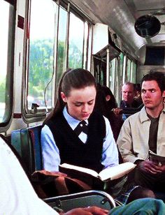 people are sitting on the bus and reading books