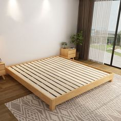 there is a bed with wooden slats on the floor next to a table and two nightstands