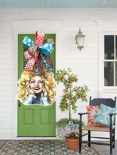 a green door with a large bow on it's head and an image of marilyn monroe