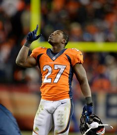 a football player is holding his hand up in the air while wearing an orange and white uniform