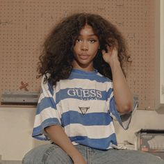 a young woman sitting on top of a counter