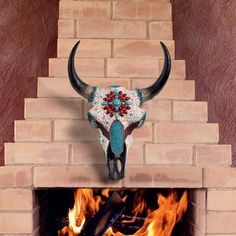 a bull's head mounted to the side of a brick fireplace