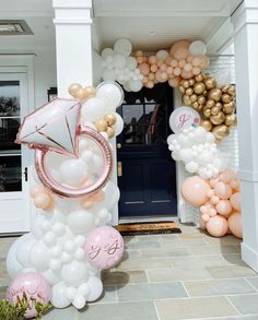 an entrance to a house decorated with balloons