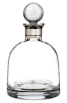 an empty glass bottle with a silver stopper on the top is shown in front of a white background