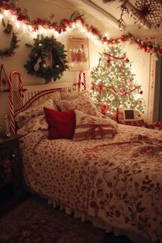 a bedroom decorated for christmas with lights on the ceiling and a tree in the corner