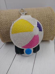 a small purse with a beach ball on it