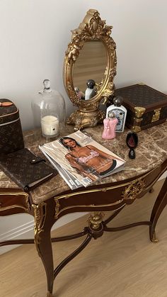 a table with a mirror, magazine and other items on it