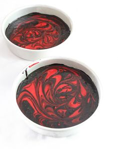 two white bowls filled with red and black liquid