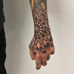 a person with a tattoo on their arm and hand