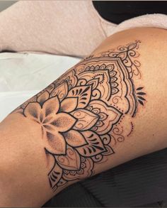 a woman's leg with a tattoo on it and a flower in the middle