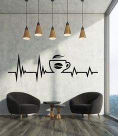 two chairs and a table in front of a wall with a coffee cup on it