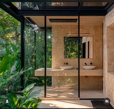 an outdoor bathroom with two sinks and mirrors