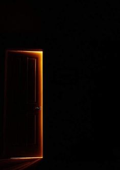 an open door in the dark with light coming from it's center and side