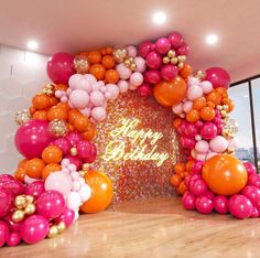 an arch made out of balloons and confetti