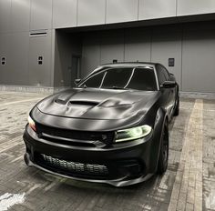 a black sports car parked in front of a building