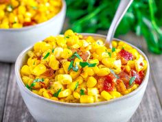 two white bowls filled with corn and bacon