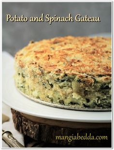 a close up of a cake on a plate with the words potato and spinach gateau