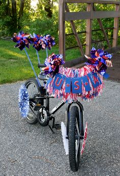 a bike decorated with red, white and blue ribbons