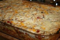 a casserole dish with cheese and meat in it