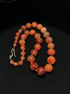 A beautiful 900 years old Pre Ankur carnelian beads necklace from Cambodia, worn by royals at that time as a luck charm. Glass beads as counters. In great condition and colors of the beads are exceptional with great shine on its surface as its been continuesly used since then till now. Carnelian Gemstone Round Beads, Round Carnelian Necklace With Polished Beads, Polished Round Carnelian Beads, Gems, And Cabochons, Carnelian Gemstone Beads Necklace, Carnelian Gemstone Beaded Necklaces, Natural Carnelian Round Beads Gemstones, Carnelian Beaded Necklaces With Gemstone Beads, Orange Agate Gemstone Beads, Orange Agate Necklace With Polished Beads