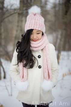 a woman wearing a pink hat and scarf in the snow