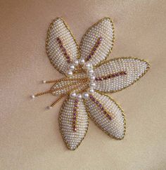 an appliqued flower with pearls on it