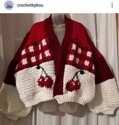 a red and white sweater with cherries on it