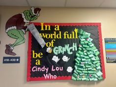 a bulletin board with candy in the shape of grinch