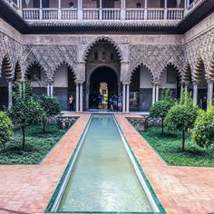 the courtyard of an old building with water running through it