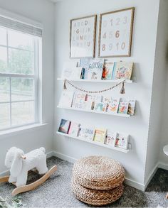 a white nursery with bookshelves and toys