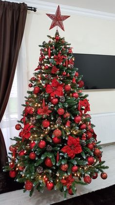 a decorated christmas tree with red ornaments