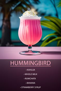 the hummingbird cocktail is served in a glass with whipped cream and garnish