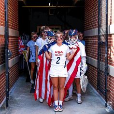 some girls are holding american flags and posing for the camera