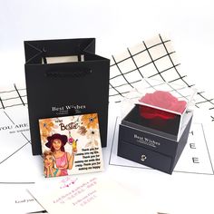 a box with a card inside sitting next to a greeting card