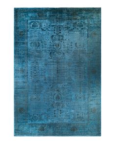 a blue rug with an intricate design on the top and bottom, in shades of teal