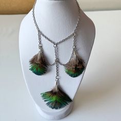 the necklace is decorated with feathers and chains