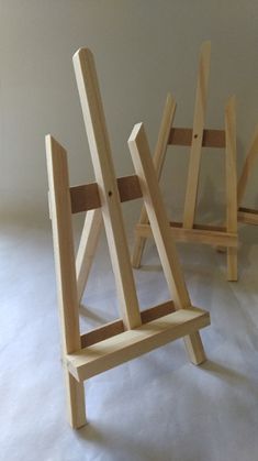 three wooden chairs sitting next to each other