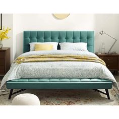 a bed with a blue headboard and foot board