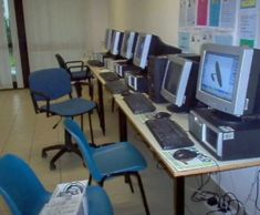 a row of computers sitting on top of desks