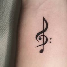 a small tattoo with a musical note on it