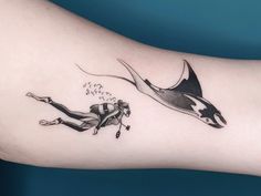 a woman with a black and white tattoo on her arm is flying through the air